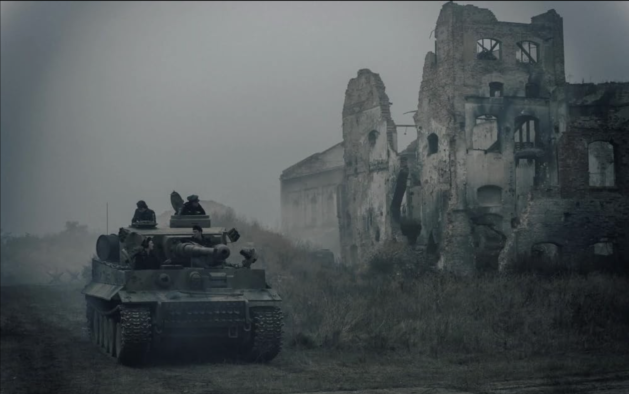 A Tiger tank from "The Tank" passes a ruined building on the Eastern Front